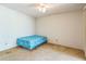 Small bedroom with ceiling fan, neutral carpet, and a twin sized bed frame at 159 Sweetgum Ln, Port Orange, FL 32129