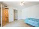Bedroom with closet, carpet, fan, and view of adjacent bathroom with floral wallpaper at 159 Sweetgum Ln, Port Orange, FL 32129
