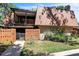 Two-story home with brick facade, balcony, fenced entry, and mature landscaping at 159 Sweetgum Ln, Port Orange, FL 32129