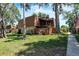 Exterior view of two-story home featuring a lawn, trees, and wooden fence at 159 Sweetgum Ln, Port Orange, FL 32129