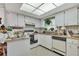Compact kitchen featuring bright cabinetry, laminate countertops, and a skylight at 159 Sweetgum Ln, Port Orange, FL 32129