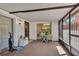Enclosed patio featuring a concrete floor, white walls, and an access door at 159 Sweetgum Ln, Port Orange, FL 32129