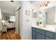 Bright bathroom features a blue vanity with a white countertop and updated lighting at 11540 Sw 84Th Avenue Rd, Ocala, FL 34481