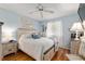 Comfortable bedroom with a queen-size bed, wood floors, and soft blue walls creating a relaxing atmosphere at 11540 Sw 84Th Avenue Rd, Ocala, FL 34481
