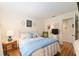 Cozy bedroom featuring natural light and a comfortable bed, complemented by simple decor and furniture at 11540 Sw 84Th Avenue Rd, Ocala, FL 34481