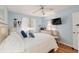 Light-filled bedroom with wood-look floors, a ceiling fan, and pale blue walls at 11540 Sw 84Th Avenue Rd, Ocala, FL 34481