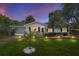 Charming single-story home with a well-manicured lawn and screened garage at 11540 Sw 84Th Avenue Rd, Ocala, FL 34481
