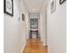 Hallway with hardwood floors and light walls, decorated with pictures at 11540 Sw 84Th Avenue Rd, Ocala, FL 34481