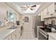 Well-lit kitchen features stainless steel appliances, tiled backsplash, and ample counter space at 11540 Sw 84Th Avenue Rd, Ocala, FL 34481