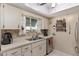 Well-lit kitchen with stainless appliances, mosaic backsplash, and bright countertops at 11540 Sw 84Th Avenue Rd, Ocala, FL 34481