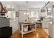 Bright kitchen featuring an island, white cabinets, and wood flooring at 11540 Sw 84Th Avenue Rd, Ocala, FL 34481