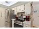 Kitchen showcasing stainless steel appliances, tiled backsplash and neutral countertops at 11540 Sw 84Th Avenue Rd, Ocala, FL 34481