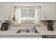 Kitchen featuring a stainless sink, white cabinets, mosaic backsplash, and ample counter space at 11540 Sw 84Th Avenue Rd, Ocala, FL 34481
