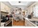 Charming kitchen with an island, stainless appliances, and wood flooring at 11540 Sw 84Th Avenue Rd, Ocala, FL 34481