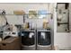 Spacious laundry room equipped with modern washer and dryer, shelving, and natural light at 11540 Sw 84Th Avenue Rd, Ocala, FL 34481