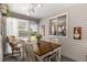 Bright sun room featuring a dining table, rocking chair, and large windows at 11540 Sw 84Th Avenue Rd, Ocala, FL 34481