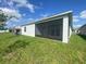 The back of the house has a screened lanai and a large yard, perfect for outdoor gatherings at 4910 Lyric Dr, Mascotte, FL 34753