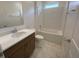 Bathroom featuring a tub/shower combo, a toilet and a modern vanity with ample counter space at 4910 Lyric Dr, Mascotte, FL 34753