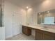Bright bathroom with double vanities, sleek mirrors, and a glass shower enclosure at 4910 Lyric Dr, Mascotte, FL 34753