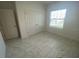 Bedroom featuring light colored walls, baseboards, door frames and decorative tile floors at 4910 Lyric Dr, Mascotte, FL 34753