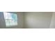 Bedroom interior featuring a window looking out to a street with mature trees at 4910 Lyric Dr, Mascotte, FL 34753