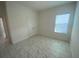 Bedroom featuring light colored walls, baseboards, door frames and decorative tile floors at 4910 Lyric Dr, Mascotte, FL 34753