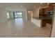 Open-concept with view of kitchen with stainless steel appliances and island at 4910 Lyric Dr, Mascotte, FL 34753