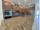 Kitchen boasts granite counters, stainless appliances, and ample cabinet space at 4910 Lyric Dr, Mascotte, FL 34753