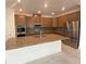 Modern kitchen with a large island, stainless steel appliances, and ample cabinet space at 4910 Lyric Dr, Mascotte, FL 34753