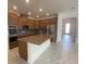 Modern kitchen featuring stainless steel appliances, granite countertops, and wooden cabinetry at 4910 Lyric Dr, Mascotte, FL 34753