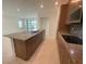 Well-equipped kitchen featuring granite countertops, a central island, and sleek, modern appliances at 4910 Lyric Dr, Mascotte, FL 34753