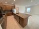Bright kitchen featuring a large island, stainless appliances, and a seamless flow to the living area at 4910 Lyric Dr, Mascotte, FL 34753