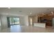 Open-concept kitchen with a breakfast bar island, providing a seamless flow to the living area at 4910 Lyric Dr, Mascotte, FL 34753