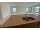 Kitchen island featuring granite countertops and a stainless steel sink at 4910 Lyric Dr, Mascotte, FL 34753