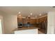 Open concept kitchen with stainless steel appliances and granite countertops at 4910 Lyric Dr, Mascotte, FL 34753