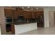 Modern kitchen featuring stainless steel appliances and a large center island at 4910 Lyric Dr, Mascotte, FL 34753