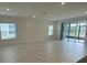 Open living room with tile flooring and plenty of natural light at 4910 Lyric Dr, Mascotte, FL 34753