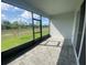 Screened patio featuring brick flooring, a covered area, and views of a lush green lawn at 4910 Lyric Dr, Mascotte, FL 34753