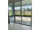 View from inside showcasing screened patio overlooking a lush green lawn at 4910 Lyric Dr, Mascotte, FL 34753