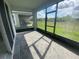 Screened patio with brick flooring and a view of the green lawn at 4910 Lyric Dr, Mascotte, FL 34753