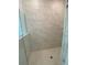 Walk-in shower featuring marble-look tile and a tiled shower floor at 4910 Lyric Dr, Mascotte, FL 34753