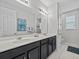 Bathroom with double sink vanity, neutral colors, and tiled flooring at 9001 Flamingo Key Way, Kissimmee, FL 34747