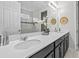 Bathroom featuring double sinks with a large mirror, and a tiled shower behind a sliding glass door at 9001 Flamingo Key Way, Kissimmee, FL 34747