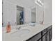 Bright bathroom featuring double sinks, a dark vanity, and a large mirror, showcasing a shower and toilet area at 9001 Flamingo Key Way, Kissimmee, FL 34747