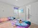 Charming bedroom featuring two twin beds with Frozen-themed bedding and decor and a mounted TV at 9001 Flamingo Key Way, Kissimmee, FL 34747