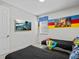 Bright bedroom with a media wall and two twin beds at 9001 Flamingo Key Way, Kissimmee, FL 34747