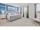 Bright bedroom with a tufted headboard bed, neutral decor, and large windows with gray curtains at 9001 Flamingo Key Way, Kissimmee, FL 34747