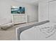 Modern bedroom featuring gray bed frame, white furniture, beach art, and comfortable seating at 9001 Flamingo Key Way, Kissimmee, FL 34747