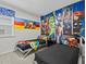 bedroom with comic hero decor, carpeting, and twin beds at 9001 Flamingo Key Way, Kissimmee, FL 34747