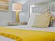 Bright bedroom features a modern lamp on mirrored end table, and decorative gold pillows on the bed at 9001 Flamingo Key Way, Kissimmee, FL 34747